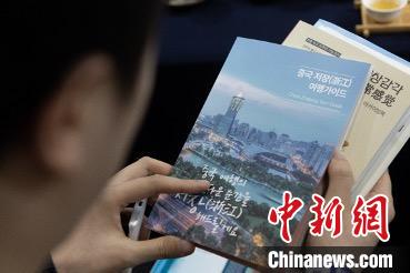 參展觀眾閱讀浙江文旅手冊(cè)?！《≌裾?攝