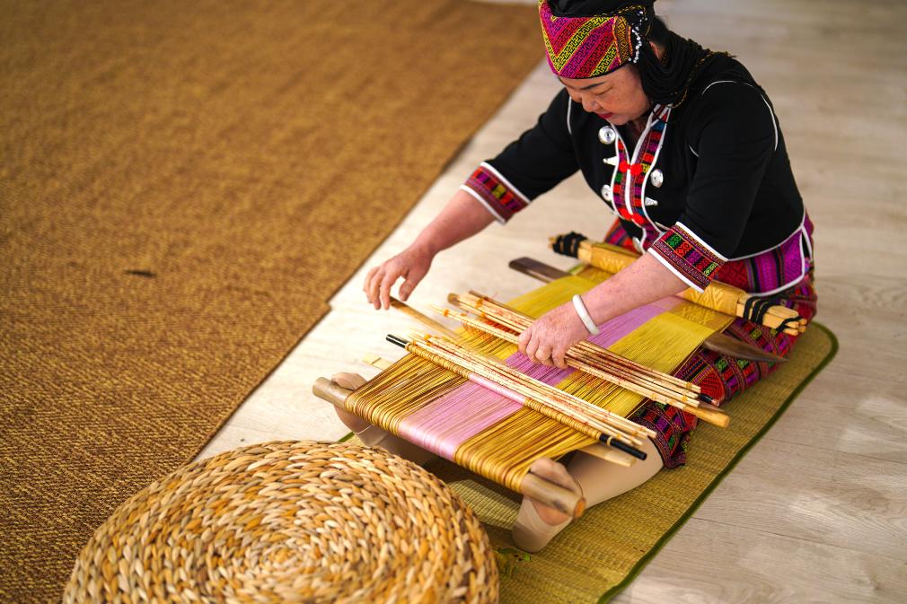 4月17日，黎族傳統(tǒng)紡染織繡技藝國家級(jí)代表性傳承人劉香蘭在2023年意大利米蘭設(shè)計(jì)周上展示黎錦織造技藝。新華社發(fā)