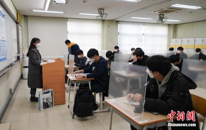 12月3日，延遲近一個(gè)月的韓國(guó)高考舉行。據(jù)韓國(guó)教育部消息，今年考生約49.34萬人，創(chuàng)歷史最低紀(jì)錄。圖為在首爾某考點(diǎn)內(nèi)，考桌上設(shè)有隔板。