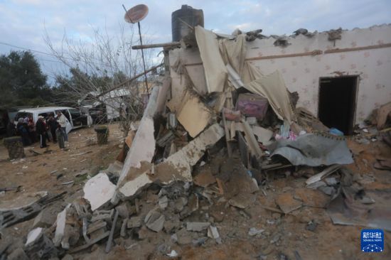 2月5日，在加沙地帶南部城市拉法，人們查看以軍空襲后的建筑廢墟。新華社發(fā)（哈立德·奧馬爾攝）