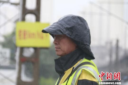 蘭州西工務(wù)段蘭州線路車間防護(hù)員雨中巡查?！⊥豕廨x 攝