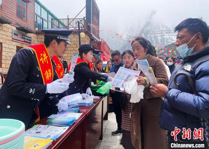 圖為山南玉麥邊境派出所民警為轄區(qū)群眾發(fā)放法律知識宣傳單?！＄婗?　攝